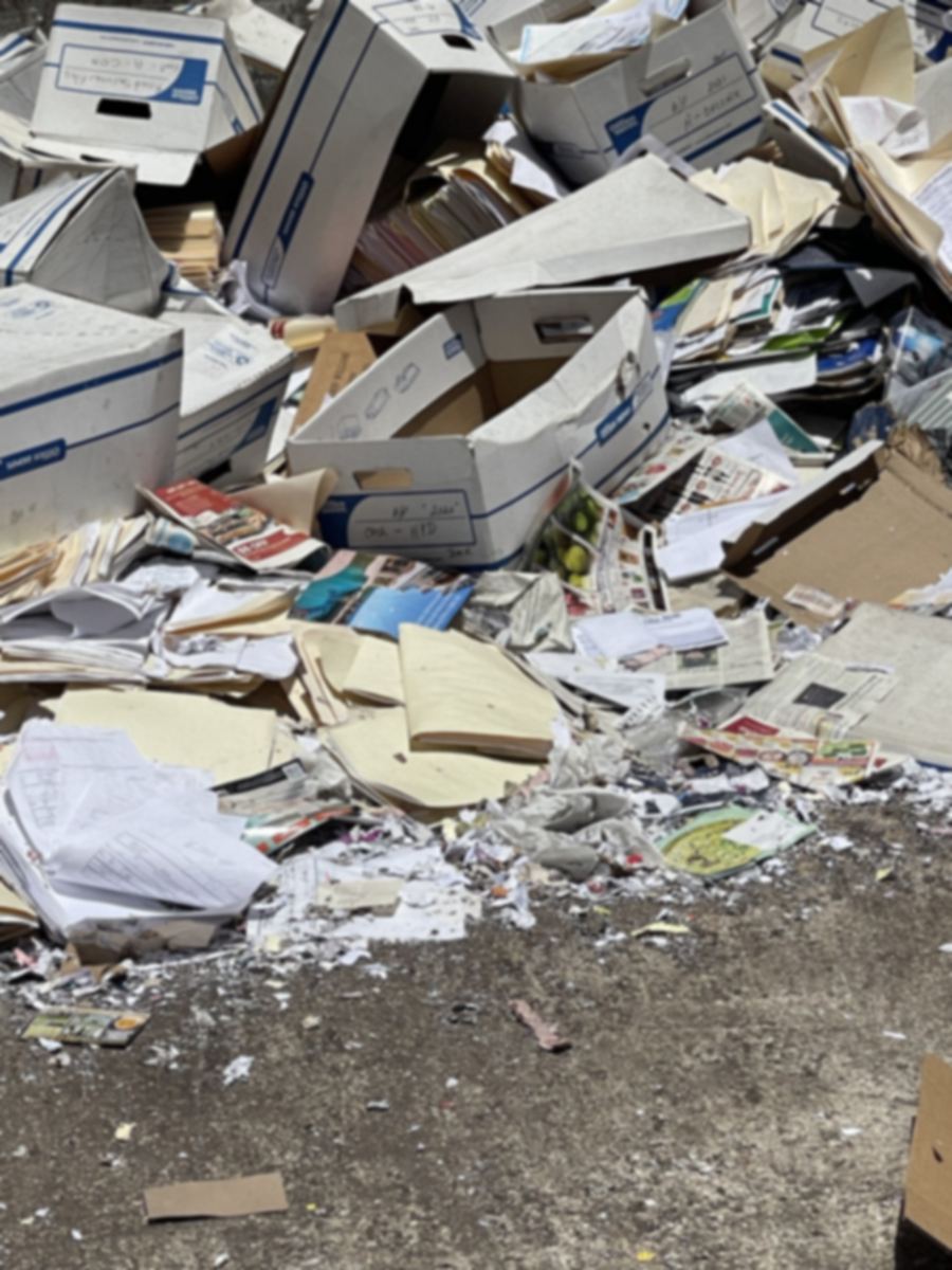 Business file boxes and folders left unshredded on the ground